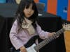 A young girl tries our an electric guitar at the School of Rock table at the NSYMCA Youth Explorer Expo on Sunday, January 12.