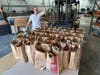 Photo 4:  Henry Fetta from the HRN Students Helping Students Campaign poses with excitement in front of some of the donated bags from past years.