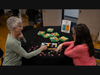 Debbie Belkin, Instructor at the NSYMCA and Becky Lee, a NSYMCA member and Volunteer, enjoy the quiet room while doing a puzzle together at the NSYMCA’s SeniorPLAYooza on May 13th. 