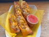Longanisa Cheese Curd Lumpia — Lumpia City rolls Filipino longanisa sausage and Wisconsin cheese curds into a deep-fried lumpia wrapper, served with sweet chili sauce.