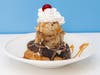 French Chouxnut Sundae — Bridgeman's Ice Cream stacks salted caramel espresso ice cream on a chocolate mousse-filled choux donut, finished with fondant icing and chocolate curls.