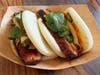Bao Belly — RC's BBQ serves smoked pork belly with hot sauce, yum yum sauce and pickled vegetables on steamed bao buns.