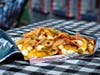 Walking Chopped Italian Grinder — Mancini's al Fresco layers a chopped Italian sandwich blend over Parmesan and garlic kettle chips with Calabrian chili aioli.