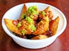 Peri-Peri Bowl — Afro Deli & Grill combines peri-peri chicken, beef sambusas and fried plantains with a choice of spicy sauces.