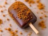 Brandy Old Fashioned Cookie Dough — Kora & Mila's Cookie Dough dips brandy-flavored cookie dough on-a-stick in chocolate and rolls it in Biscoff crumbs.