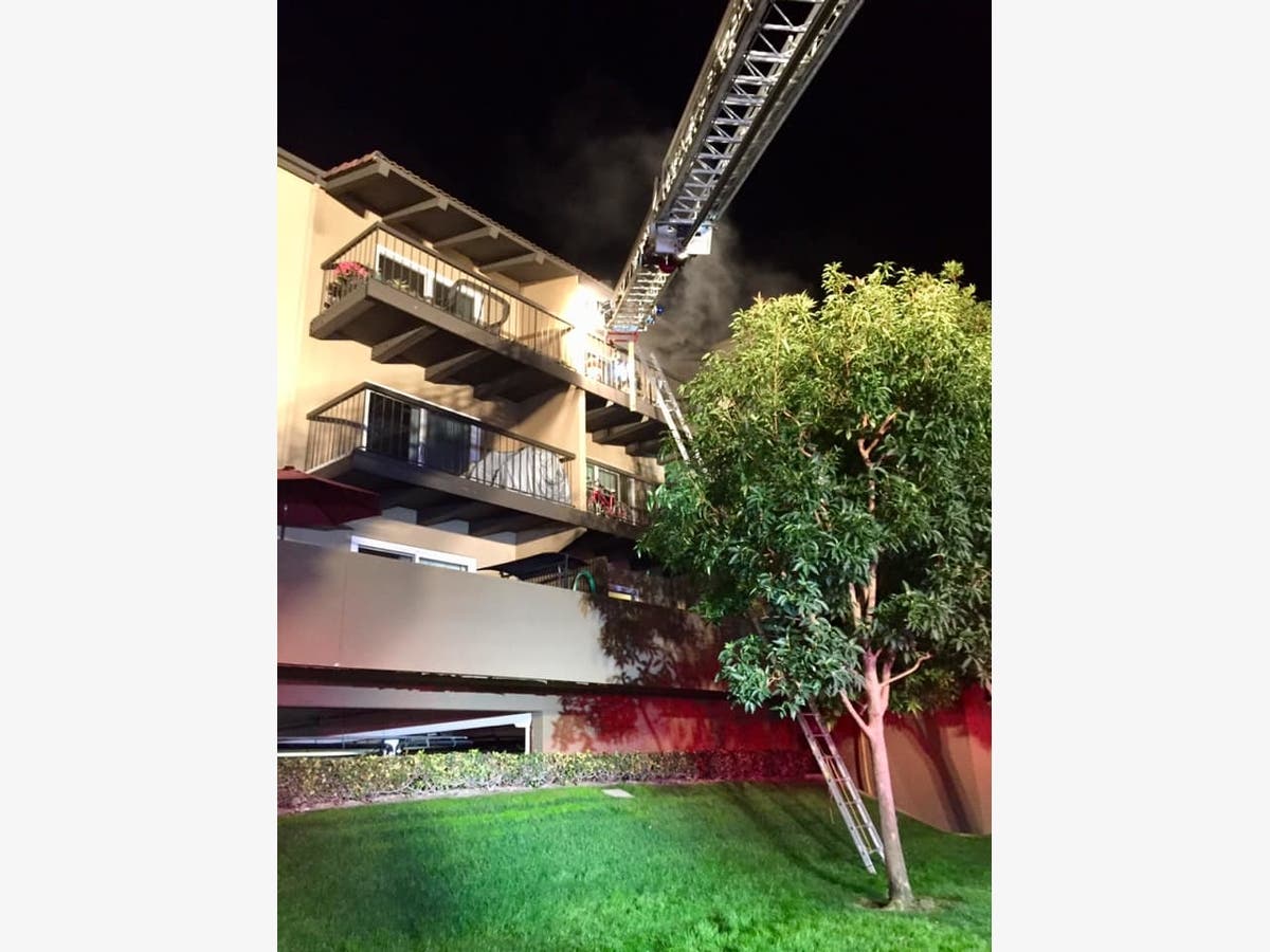 Newport Beach Firefighters rescued a nude woman from the balcony of her fourth story apartment.