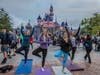 Yoga in front of Sleeping Beauty's Castle at Disneyland.