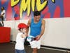 Mario Lopez helps son, Nico, navigate the skate course during an open session at the #BonesLoveMilk Shredquarters in Huntington Beach, Calif.