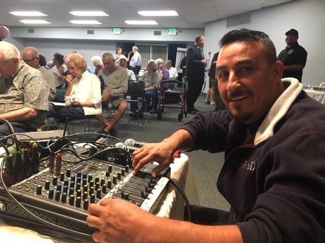 RCSD Park Superintendent Omero Perez helps with the sound at the Street Sweeping Stakeholders Meeting.