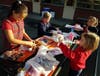 Assembling the stuffed animals at St. Bonaventure School, clockwise from center: Diego, seventh grade, Scarlett, first grade, Kensington, first grade, Veronica, third grade.