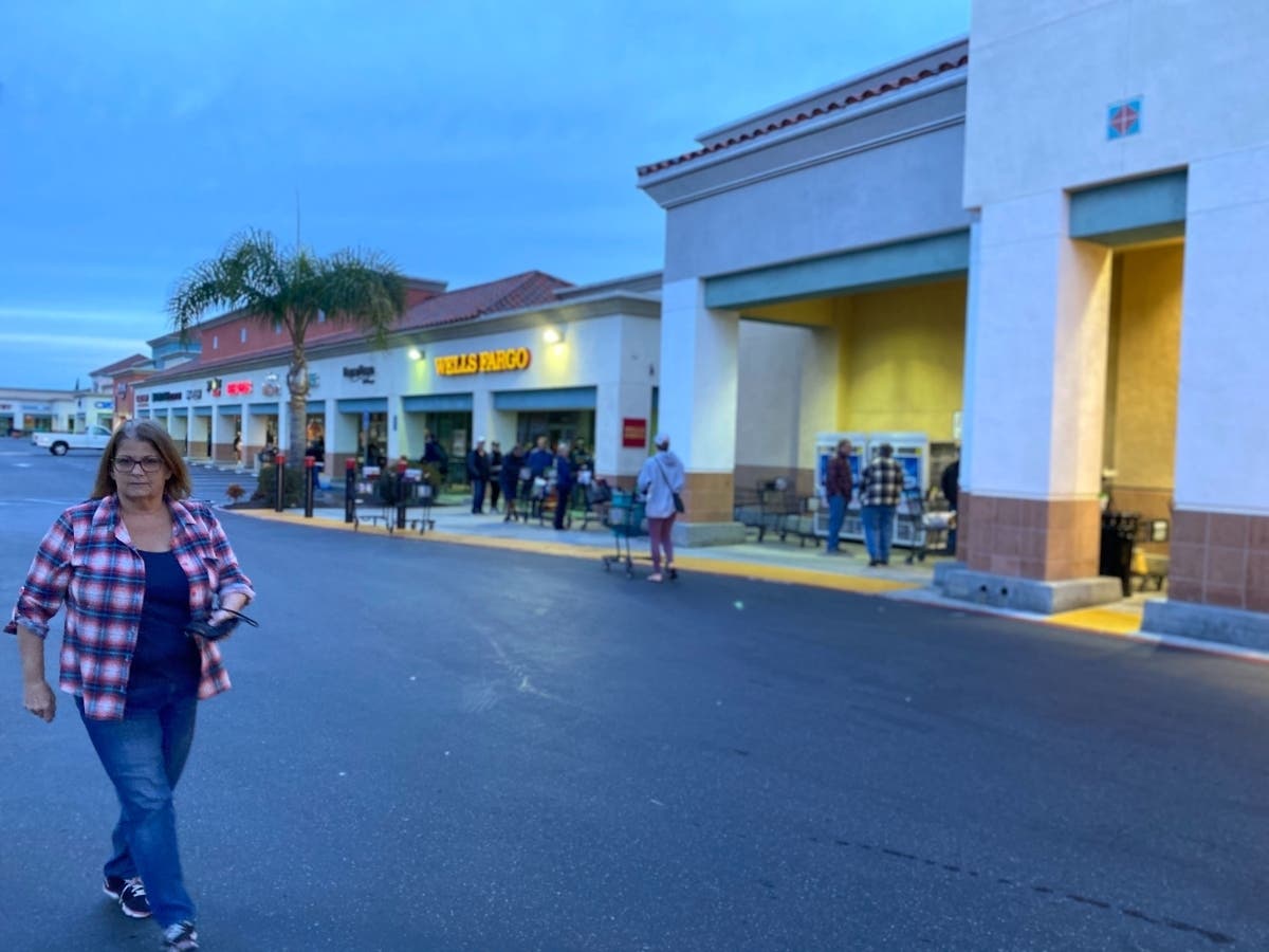 Shoppers head to Vons in Garden Grove Wednesday, in search of basic items.