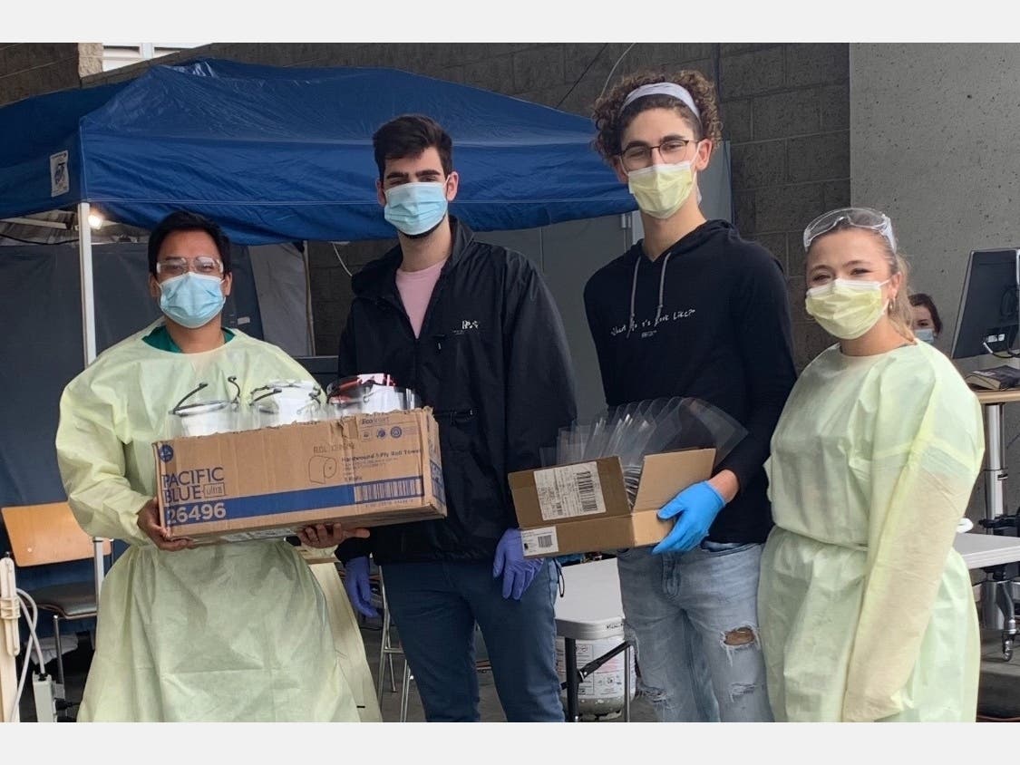 Alexandros (left) and Matt Drivas deliver face shields to St. John's Hospital.