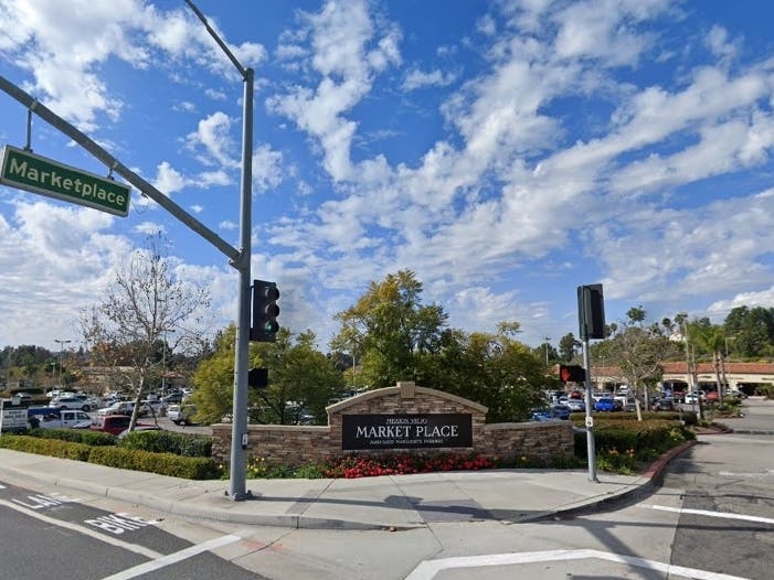 A large white work truck was on its side, Thursday, after colliding with a Nissan, Mission Viejo Police Services & OC Firefighters on scene.