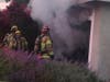 Firefighters confront a garage fire burning in the Mission Viejo area.