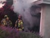 Firefighters confront a garage fire burning in the Mission Viejo area.