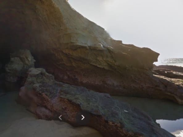 Graffiti covering the porous surface of this Thousand Steps sea cave has created controversy on who is responsible for its clean-up.