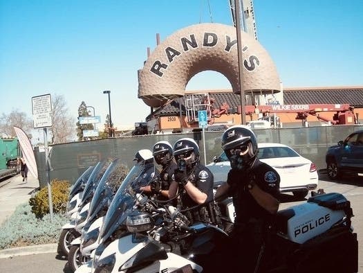 Costa Mesa Police were on hand for the building of the huge doughnut that tops the new Randy's Donut location.