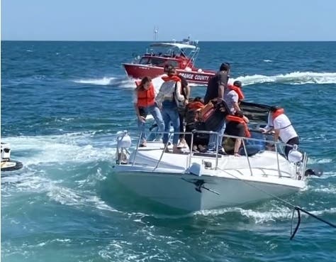 A Good Samaritan boat was towing the vessel, but it was sinking quickly and was almost submerged. All 14 passengers on the vessel jumped into the water, and all were saved.