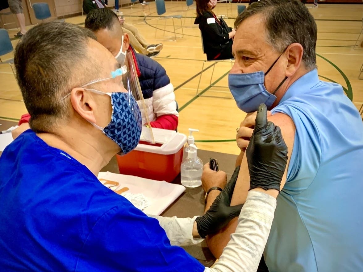Supervisor Don Wagner of Orange County's 3rd District gets his coronavirus vaccine from Dr. Clayton Chau in early April.