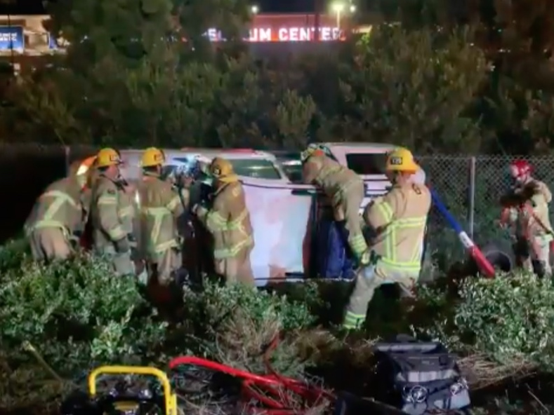 Orange County Fire Authority rescued three people in an overturned car on the I-5 Freeway Wednesday night.