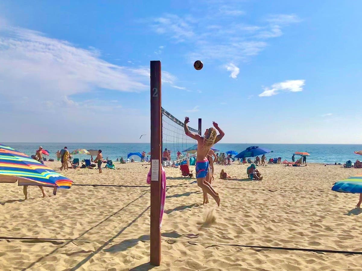 Summer sticks around through the weekend in Laguna Beach, with warm weather to spare. Here, a volleyball player mid-spike, at Main Beach. 
