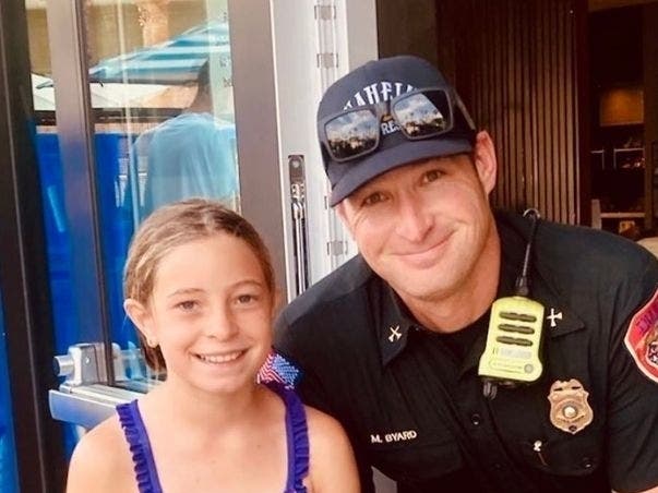 Kennady Hill and Anaheim Fire Captain Michael Byard after the rescue.