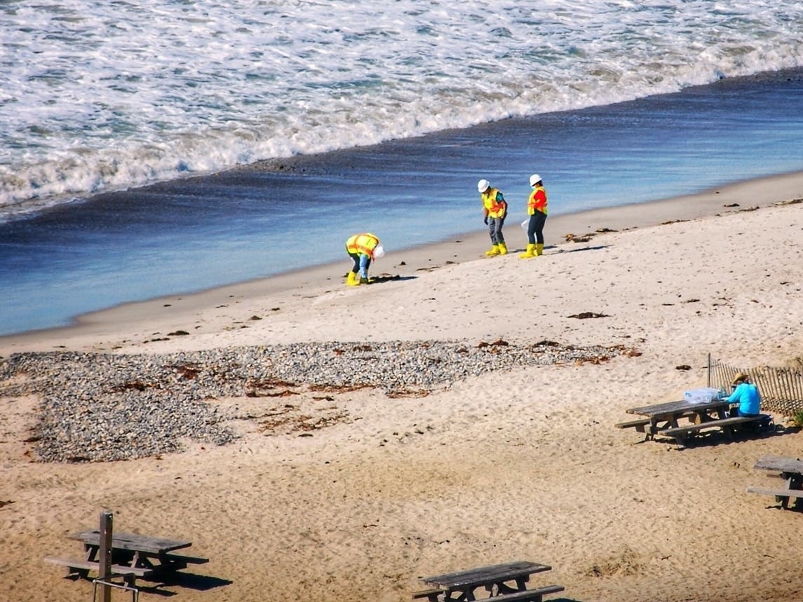 Cleanup workers along the shore of Doheny State Beach as oil spill heads southward. 