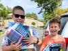 Smiling faces of Konner and Karter Desteuben, Lake Elsinore, who received backpacks and school supplies from Community Outreach Ministry and author Tamika Burgess.