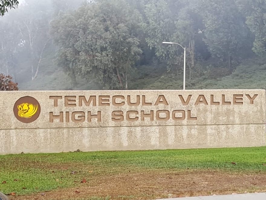 Temecula Valley High School responds to families after a traffic incident after school on Tuesday.
