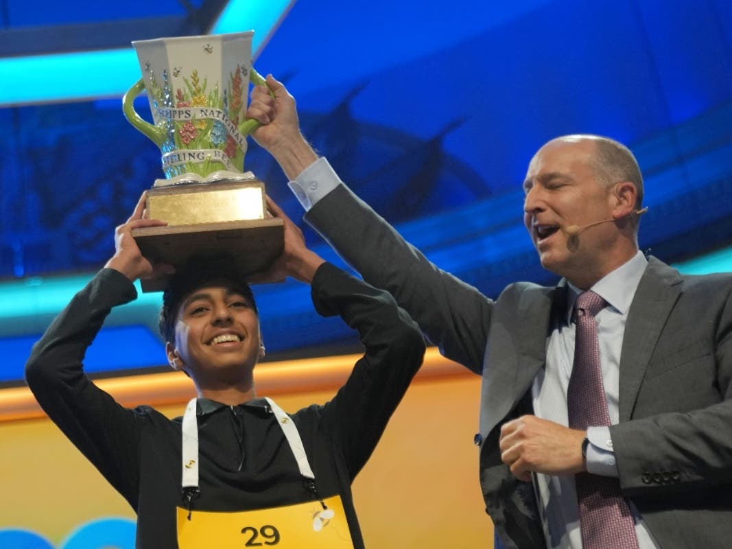 E.W. Scripps Company president and CEO Adam Symson, right, holds the trophy over winner of the 2026 Scripps National Spelling Bee, Shrey Parikh, 14, of Rancho Cucamonga, Calif., at DAR Constitution Hall, Thursday, May 28, 2026, in Washington.