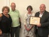 CEO John Somes and board member Alan Hartnett and president Cheryl Macdonald awarding Y Volunteer of the Year Jacqueline Rapisardi.