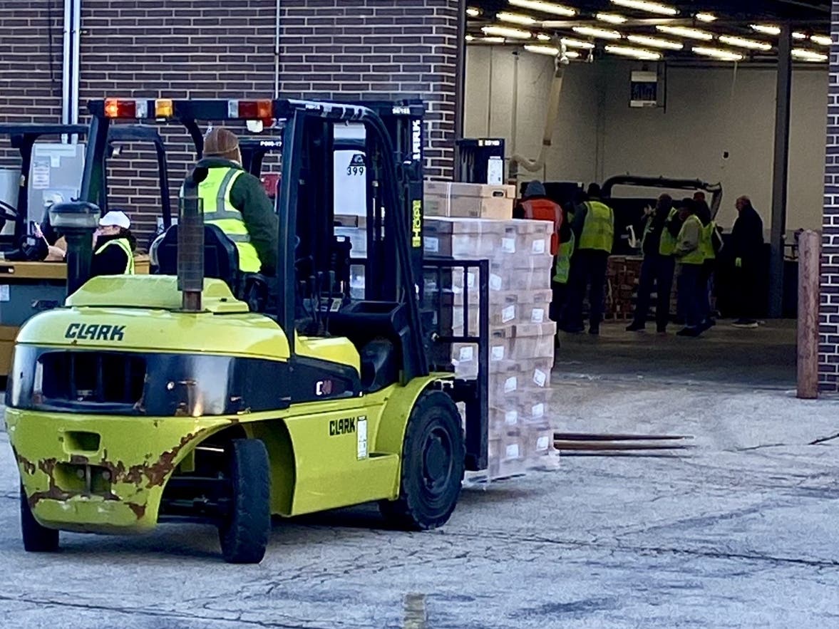 During Hunger Resource Network's recent Community Outreach Day, a volunteer moves pallets of packaged frozen chicken being loaded into scores of trucks enroute to nearly 100 food pantries, soup kitchens and shelters throughout Chicagoland. 