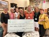 Village Treasure House grant funding now exceeds $4 million since 1998.  Holding the oversized commemorative check are volunteers (left to right): Jill Ruter, Deedee Brannigan, Sharon Kaczmarek, Sandy Van Epps, Sally Claffey, Wendy Ban and Stevie Gilson. 