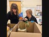 Roxanne Dunn, Northfield Township Food Pantry (left), and Merle Terry, long-time volunteer, prepare food items for visitors to the pantry. Village Treasure House supports the Angel Fund Program funding specific unmet emergency needs of Township residents.