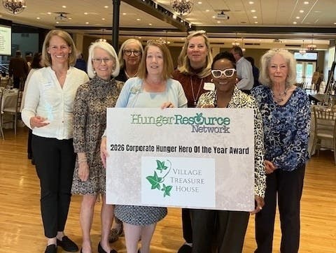 Village Treasure House volunteers display the Corporate Hunger Hero of the Year Award presented by Hunger Resource Network. From left to right: Wendy Ban, Deedee Brannigan, Odette Zebel, Sharon Kaczmarek, Sally Claffey, Kerry Smith, HRN, and Kathryn Hall