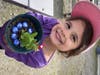 Children's House student displays her planting skills.