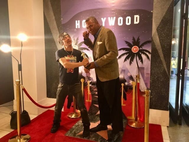 A REUNION FILLED WITH POETRY AND PERFORMANCE!: Veteran Chicago Stage Actors and Excaliber Shakespeare Company Members Danny Belrose And Darryl Maximilian Robinson have a mock fight over fake Oscars at SWEET! in The Hollywood and Highland Center of LA.