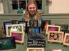 Olivia selling her original photographs at Empower Her's Ladies Nite Out.