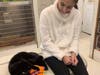 Alana giving a cat the catnip toy she made. (Also the cat she adopted!)