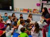 New Marion Street Elementary School teacher Nicole DiCarlo (right) read a story to her first grade class on the first day of school. 