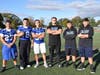 Members of the Calhoun football team toss the ball around ahead of their Friday night lights game against Sewanhaka High School.