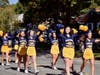 The cheerleaders marching in the parade and later performed a spirited routine during halftime