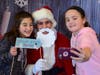 Sixth graders Nadia Ivancich, left, and Samantha Dolan took a selfie with Santa.