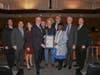 Drew Hanson, center, was honored for saving a family from a car crash while he was on his way to work.