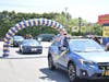 As the parade arrived at the high school, cars passed underneath a blue-and-gold balloon arch. 