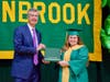 Lynbrook High School Principal Joseph Rainis (left) presented a diploma case to senior Nicole D’Agostino.
