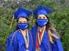 Valedictorian Talia Cartafalsa, left, and salutatorian Alexa Mangione showcased the masks that all graduates wore before they crossed the stage. Their pre-recorded commencement speeches were played over large screens. 