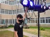 Chris Sotirakas adjust lighting before the courtyard performance of Shakespeare Revued.