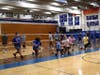 Athletes warm up before volleyball drills.
