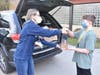 Student council officer handed adviser Kristen Meoli a bag of sorted food donations, to be delivered to the St. Rose of Lima parish outreach center.